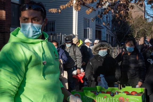 Javier Correa, “Chalino,” created a mobile community center outside his house in Queens. Each Saturday, he and a dozen volunteers and neighbors distribute food to familias, administer Covid-19 tests, and conduct routine medical exams. (Ximena Natera)