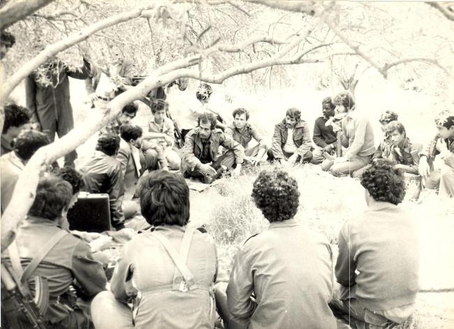 Schafik Handal sits with members of the Democratic Front for the Liberation of Palestine (DFLP) in an olive grove in Lebanon, c. 1981. (Casa Museo Schafik Handal, San Salvador / CC BY 4.0)