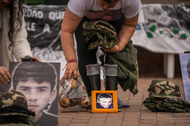 Carmenza Gómez assembles an altar for her son Víctor, killed in 2008 when he was 23 years old. (Diego Cuevas)