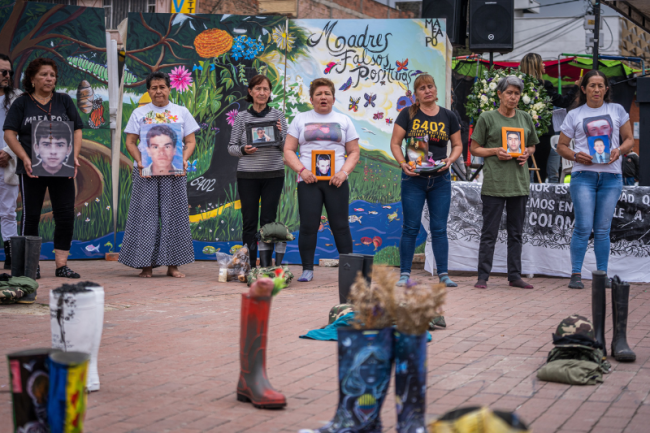 The Mothers of Soacha activate a living monument together using boots decorated with the works of artists and everyday people, April 16, 2023. (Diego Cuevas)