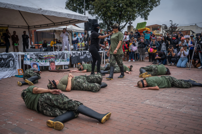 Marking 15 years of struggle in 2023, the Mothers of Soacha staged a performance in which they dressed in camoflauge in the central square of Soacha, symbolizing what was done to the bodies of their children. (Diego Cuevas)