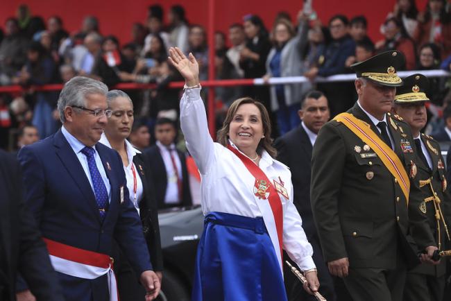 Peruvian President Dina Boluarte waves at a crowd at the Grand Parade and Military Civic Parade for the 203rd Anniversary of the Proclamation of National Independence on July 29, 2024. (Presidencia Perú/ Flickr/ CC BY-NC-SA 2.0)