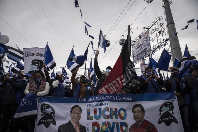 Attendees wave flags and hold signs during a campaign rally for presidential candidate for the Movement for Socialism party (MAS) Luis Arce in La Paz, Bolivia, on Wednesday, Oct. 14, 2020. (Marcelo Pérez Del Carpio)