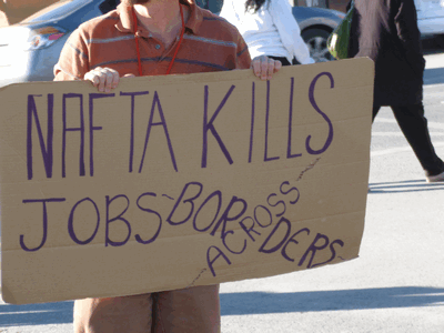 "NAFTA kills jobs across borders\" a 2012 protest sign reads (Billie Greenwood/ Flickr)