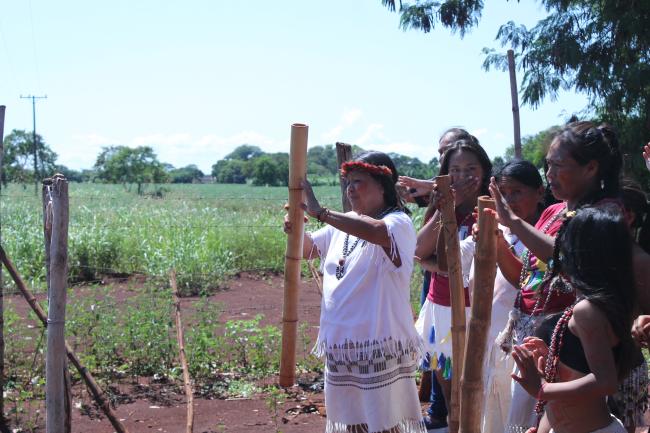Kaiowá women conduct a ceremonial dance before entering the oypysy. The community is surrounded by soya fields. (William Costa)