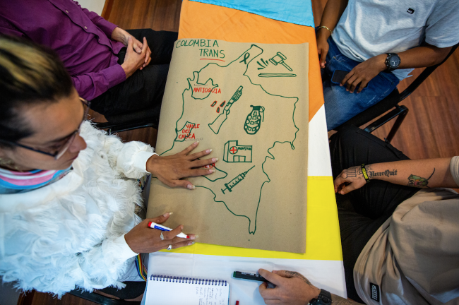 Danna Cuellar, a former FARC militant, draws a map with symbols from the armed conflict as part of a workshop at the two-day event. (Antonio Cascio)