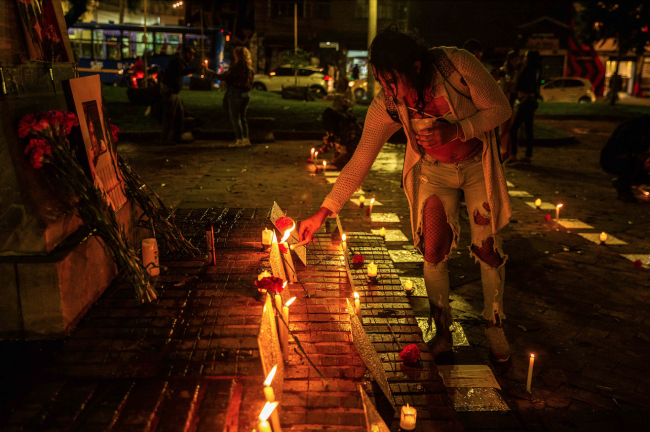 A trans woman lights a candle during a demonstration in Bogotá for International Transgender Day of Remembrance to commemorate trans people that have been killed. Colombia has the second highest rate of trans killings in Latin America. (Antonio Cascio)