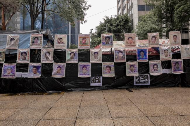 The anniversary march commemorated the 43 disappeared students by displaying posters with their faces and the phrase “¡Vivo se los llevaron! ¡Vivo los queremos!” (“Alive they took him! Alive we want them!) (Anita Pouchard Serra)