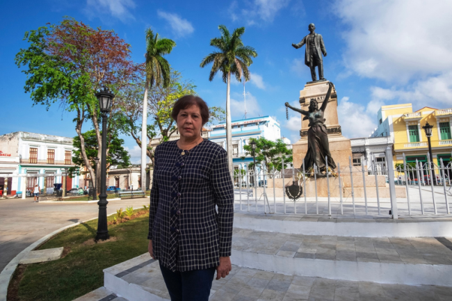 Alina López Hernández stands in from of statue of José Martí in Parque de la Libertad, Matanzas, Cuba. (Julio César García)