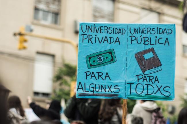  Students march in defense of public university education in Santa Fe, Argentina, on April 23, 2024. A protester holds up a sign translated to "Private University: For Some, Public University: For All." (Wikimedia Commons/Gisela Curioni/CC BY-SA 4.0)