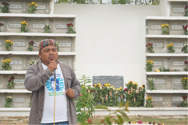 Chub Caal speaks at the commemoration of the Sepur Zarco trial in front of a memorial that contains the remains of massacre victims on February 26 (Rich Brown)