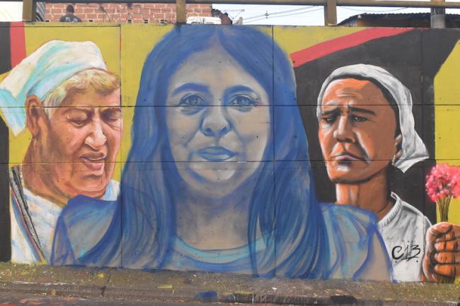 A mural in Comuna 13 depicting victims of state violence in Colombia. (Joshua Collins)