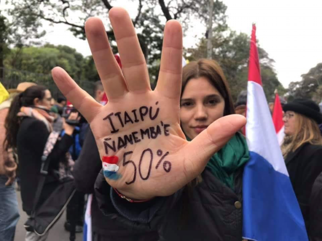 A protester with the words "Itaipu is ours" written on her hand in Guaraní demonstrates in Asunción, Paraguay, in early August. (Photo by Itaipu ñane mba'e/Facebook)