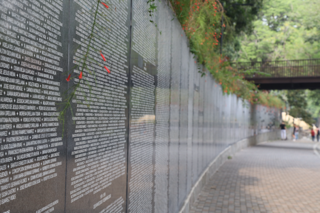A memorial in San Salvador lists the names of victims of El Salvador's armed conflict. (Michael Fox)