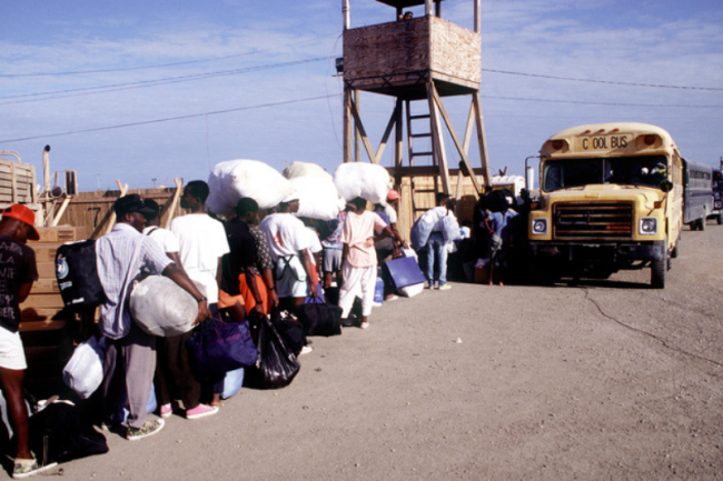 Haitians board buses during processing at Guantanamo Bay, Cuba, December 31, 1994. (U.S. National Archives)