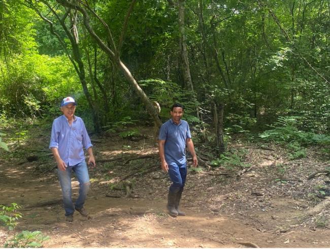 Hugues Martínez and activist Ifener Mendoza giving a tour of the forest and spring. (Emma Banks)