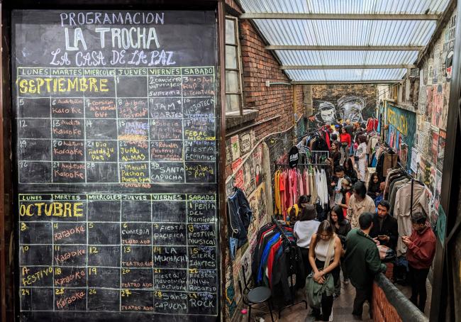 An events schedule and second-hand clothing market on the back patio of La Casa de la Paz (Joe Hiller)