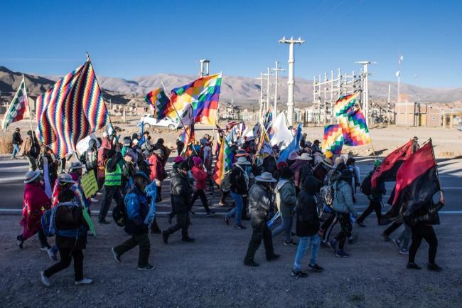 Protestors are seen marching in Jujuy. Several people are holding the seven-colored, square patchwork Wiphala flag, which represents many Indigenous peoples across the Andes and northern regions of the Southern Cone. (Susi Maresca)