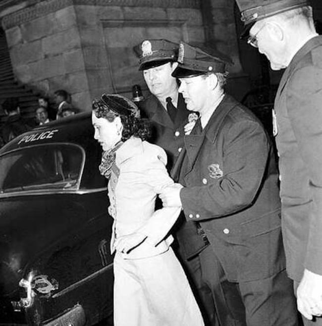 Lolita Lebrón being held by two police officers in 1954, after shooting five U.S. congressmen in Washington D.C. (Wikimedia Common / U.S. Library of Congress /cph.3c25396) 