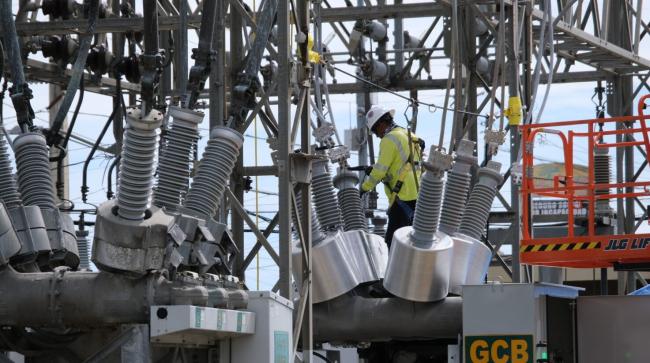 Energy corporation LUMA will enact "island-wide vegetation clearing" that will harm Puerto Rico's air, land, and water. LUMA shared this image of a worker on September 18 with the caption "Construyendo un mejor futuro energético" (LUMA Energy / Facebook)