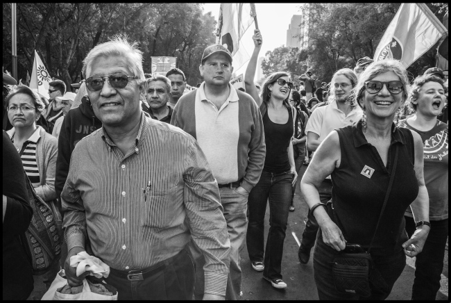Benedicto Martínez and Robin Alexander march together in Mexico City in a 2014 national protest on the 20th anniversary of the implementation of the North American Free Trade Agreement (NAFTA). (David Bacon)