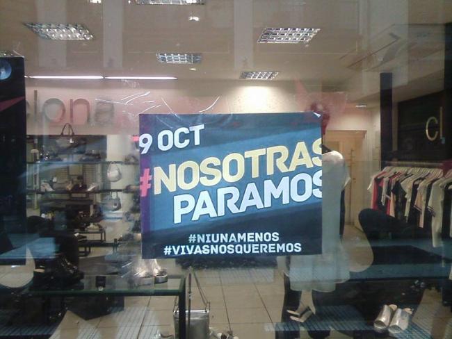 A storefront in Buenos Aires displays a poster calling for a women's strike (Photo by Natacha Ebers)