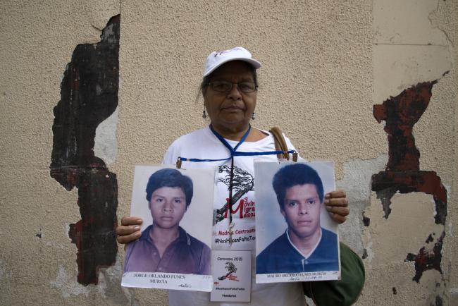 Clementina Murcia González, from Honduras, holds up the pictures of her two missing sons, Jorge Orlando Funes Murcia and Mauro Orlando Funes (Photo by Federico Barahona)