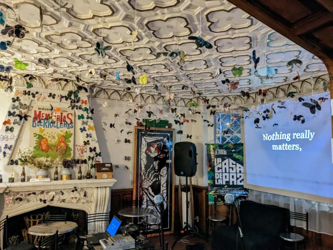 Paper butterflies hang from the ceiling of La Casa de la Paz on karaoke night (Joe Hiller)