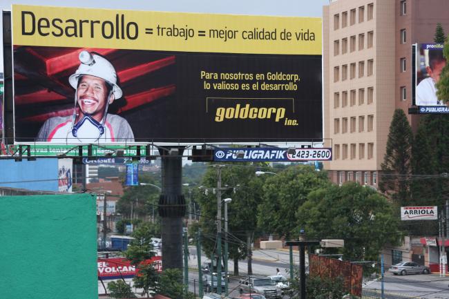 A Goldcorp billboard posted in Guatemala City during a heavy propaganda campaign in 2008 -2009. The sign reads: \"Development = work = better quality of life. For us at Goldcorp, development is the most valuable.\"  (Photo by James Rodriguez)