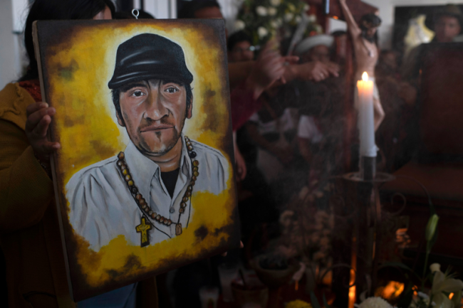 A portrait of Father Marcelo Pérez rests atop his coffin during the wake at his parents' home in San Andrés Larráinzar, Chiapas, October 21, 2024. (Encarni Pindado)