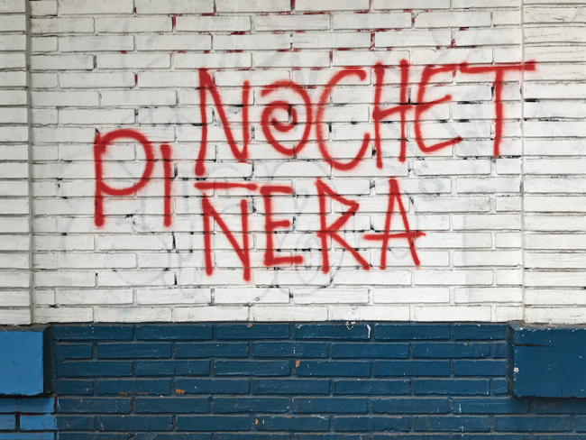 Graffiti in the middle-class neighborhood of Ñuñoa provides an example of the polemical equivalency drawn by protesters between the dictatorship of General Augusto Pinochet and President Sebastián Piñera. (Eric Zolov)