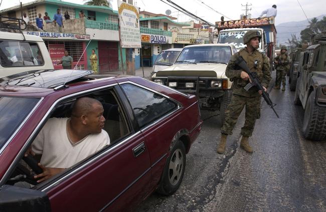 U.S. Marines patrol the streets of Port-au-Prince, Haiti during the 2004 coup against Haitian President Jean-Bertrand Aristide. (Tech. Sgt. Andy Dunaway, U.S. Air Force, Wikimedia Commons)