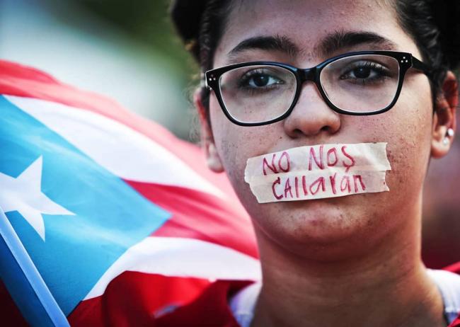 A protester participates in a silent march against the fiscal control board in May 2017. (@wandalizvega/Instagram)
