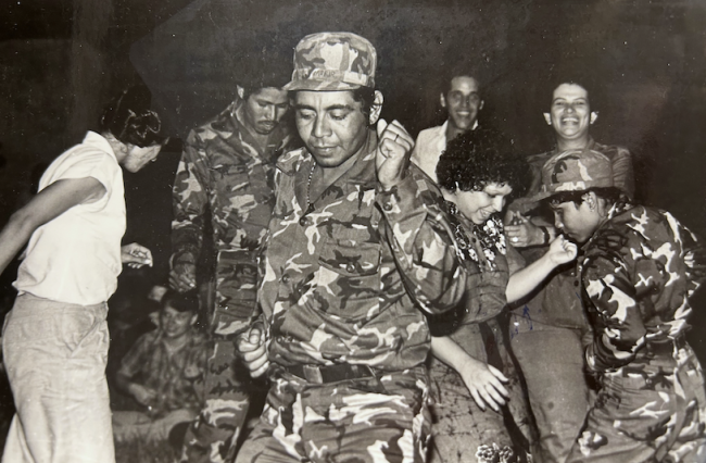 Sandinista soldiers dance with members of a cultural workers' association, after a battle in Los Planes, circa 1982/1983. (Margaret Randall / NACLA archives)