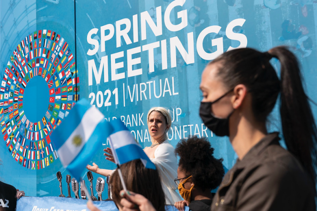 People wave Argentina flags during a protest outside the 2021 Spring Meetings at the International Monetary Fund in Washington, DC, April 8, 2021. (IMF Photo / Joshua Roberts / Flickr)