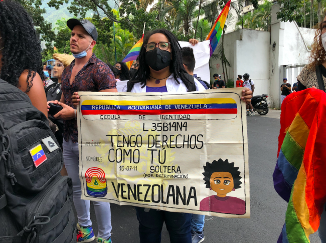 At an LGBTQI rights demonstration in Caracas, a protest sign made to look like an ID card reads: "I have rights like you" and "single (because of discrimination)," November 28, 2021. (Egloris Marys / Shutterstock)