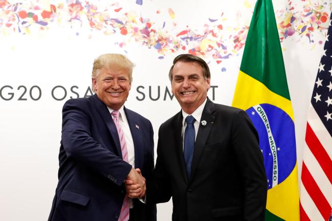 President Trump meets with far right former Brazilian President Jair Bolsonaro at the G20 summit in Japan in 2019. Bolsonaro now faces multiple charges for an attempted coup and assassination plot after losing a reelection bid in 2022. (Palácio do Planalto / CC BY 2.0)