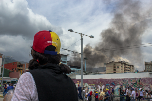 Smoke rises from a police truck burned during an anti-government protest in Mérida, Venezuela, October 2016. (sebastorg / Shutterstock)