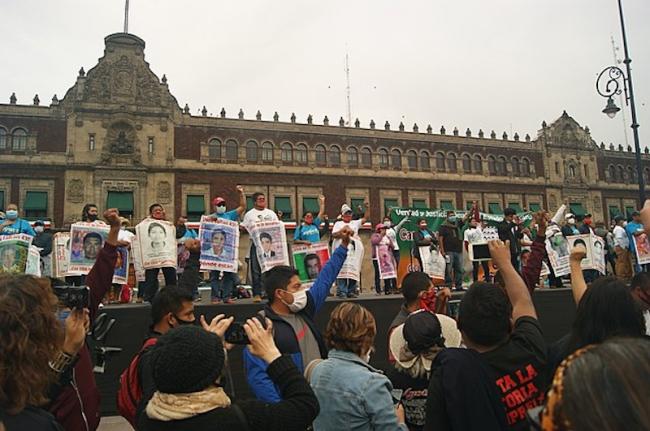 Protesters raise their fists in the air at a rally on September 26, 2020, demanding justice for the 43 students who disappeared from Ayotzinapa. (PetrohsW/Wikimedia Commons/CC BY-SA 4.0)