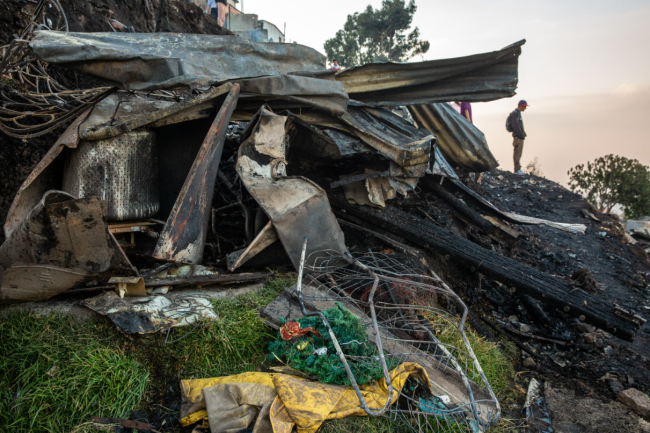 The remains of one of the seven houses burned down in an informal settlement in the neighborhood Ciudad Bolívar. Houses in this area are made of material like zinc, wood, and cartons, which creates increased fire risk. (Antonio Cascio)