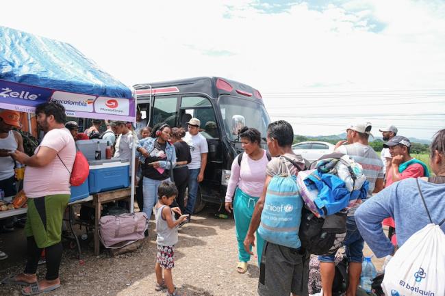 After receiving humanitarian assistance, people await buses, costing up to $45 USD, headed for Guatemala outside an attention centre in El Paraíso, Honduras. (Timothy O'Farrell)