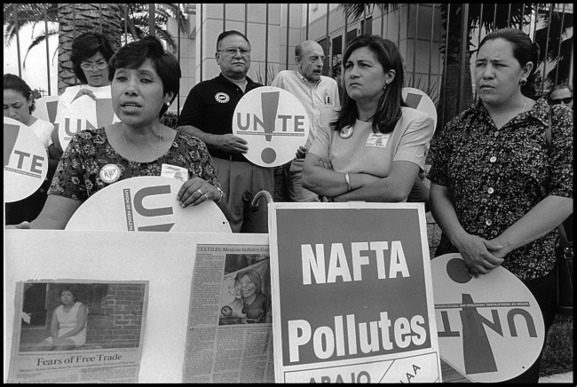 Workers and organizers of the garment workers' union UNITE demonstrate outside a sewing factory in Vernon, California. The factory closed and moved to Mexico in the wake of NAFTA's passage. (David Bacon)