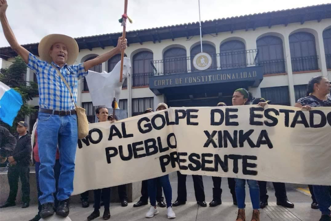 Frente a la Corte de Constitucionalidad, miembros del pueblo Xinka levantan una manta que dice "No al golpe de Estado. Pueblo Xinka presente." Tomada el 20 de octubre de 2023. (Glenda María Alvarez Salazar, periodista comunitaria de Santa Rosa, Guatemala)