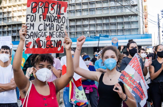 "Brazil was founded on Black and Indigenous blood." Demonstrators protest against President Jair Bolsonaro in Curitiba, Brazil, May 29, 2021. (Oruê Brasileiro / MÍDIA NINJA / CC BY-NC 2.0)