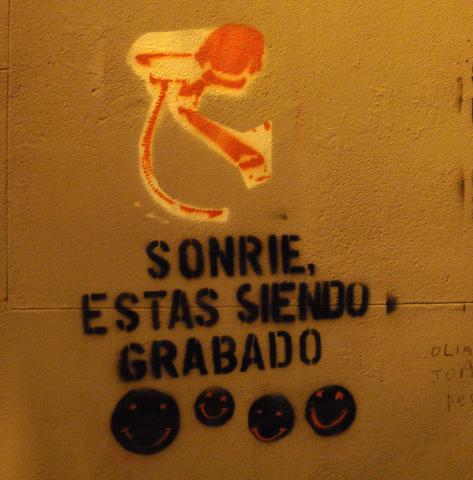 Street art reads: “Smile, you’re being recorded.” (Daniel Lobo / Creative Commons).